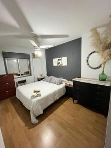 a bedroom with a large bed and a dresser at Peatonal Santafesina in Santa Fe