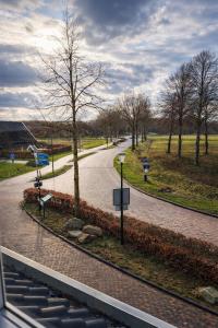 a winding road in a park with a tree at Hotel de Koningsherberg in Anloo