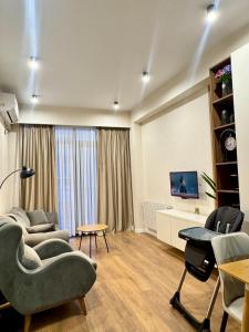 a living room with a couch and a table at Fatmanis 98 in Tbilisi City