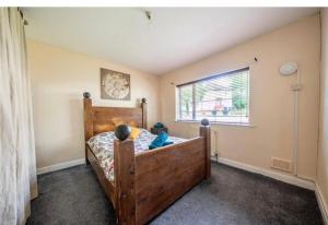 a bedroom with a wooden bed and a window at Sand-Ring-Ham in Moortown
