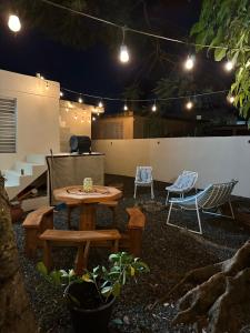 a patio with a table and chairs at night at Secrete Garden in San Juan