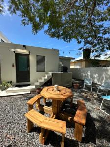 a wooden table and bench in a yard at Secrete Garden in San Juan
