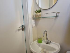 a bathroom with a sink and a mirror at Céu Sol Sul in Porto Alegre +23 photos