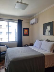 a bedroom with a large bed and a window at Céu Sol Sul in Porto Alegre