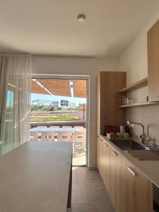 a kitchen with a counter and a table with chairs at Terra Rossa Residences in Paralimni +21 photos