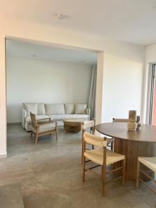 a living room with a couch and a table and chairs at Terra Rossa Residences in Paralimni