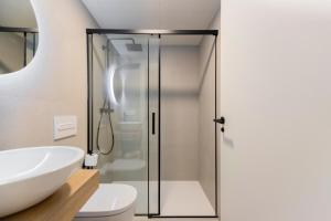 a bathroom with a glass shower stall and a sink at ARENA byAstiblanco in Valencia