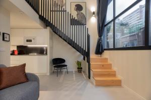 a living room with a staircase and a chair at ARENA byAstiblanco in Valencia +105 photos