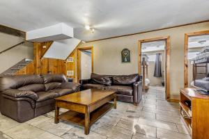 a living room with a couch and a table at Mountain View-Backyard-Air-Conditioning-BBQ-15mins walk Blue Mountain Village in Blue Mountains