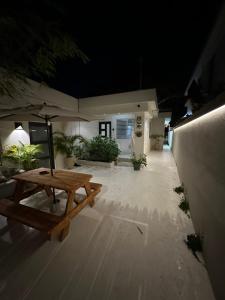 a picnic table on a patio at night at Villa Bamboo in San Juan