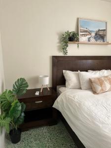 a bedroom with a bed and a table with a plant at Villa Bamboo in San Juan