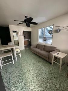 a living room with a couch and a table at Villa Bamboo in San Juan