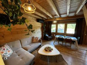 a living room with a couch and a table at Cottage relaxant au bord de l'eau in Bourbourg
