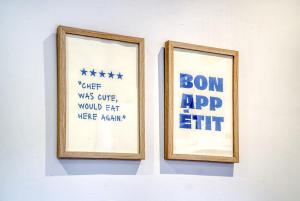 two framed pictures on a white wall with stars at Gleanings Cottage in Bredon