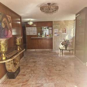 a lobby of a building with a flower arrangement on a table at Hotel polly in Mexico City