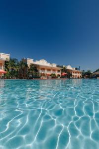 a pool of water with buildings in the background at Telamar Resort in Tela +32 photos