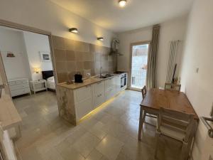 a large kitchen with a table and a dining room at Barbacana Monopoli in Monopoli
