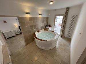 a large bathroom with a large tub in a room at Barbacana Monopoli in Monopoli