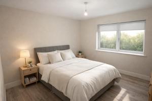 a bedroom with a large bed and a window at 5 Bedroom Home Monaghan Town in Monaghan
