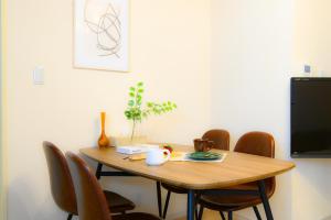 a dining room table with chairs and a television at Odori 601 Max 7 guests Odori Park 4m Tram 2m Subway 4m in Ōdōri +63 photos