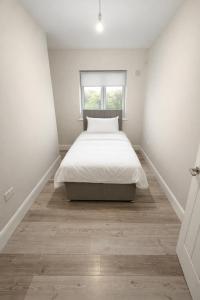 a bedroom with a bed and a window at 5 Bedroom Home Monaghan Town in Monaghan