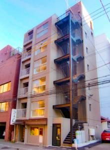 an apartment building with fire escapes on the side of it at Odori 601 Max 7 guests Odori Park 4m Tram 2m Subway 4m in Ōdōri