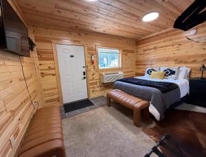 a bedroom with a bed in a log cabin at A Night In Northfield in Hixton