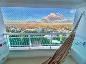a hammock in a room with a view of a city at Studio 603 Estilo, conforto e ótima localização in Juazeiro do Norte
