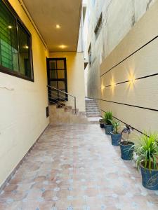 a hallway of a building with potted plants at Heritage Heaven by Premium Suites in Karachi