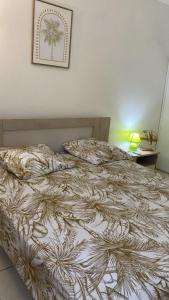 a bed in a bedroom with a picture on the wall at La Fleur des Caraïbes in Saint-Claude +8 photos