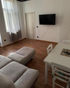 a living room with a couch and a table at SuiteMazzini in Lamezia Terme +3 photos