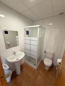 a bathroom with a sink and a toilet and a shower at Albergue Valmadrid in Valmadrid