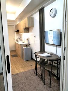 a room with a table and a kitchen with a desk at Condominium luxury with balcon ocean breeze in Davao City