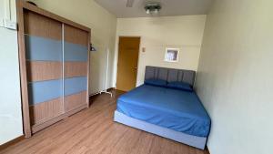 a bedroom with a large bed and a closet at De'Bestari Homestay in Ipoh