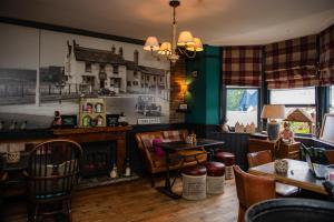 a restaurant with a fireplace and a table and chairs at Grantham Arms in Boroughbridge