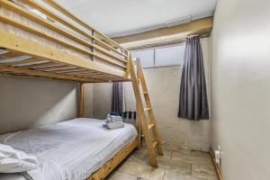 a bedroom with two bunk beds and a ladder at Mountain View-Backyard-Air-Conditioning-BBQ-15mins walk Blue Mountain Village in Blue Mountains
