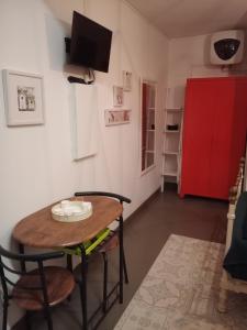 a room with a table and chairs and a red refrigerator at Studio Barbotan-les-Thermes in Cazaubon +2 photos