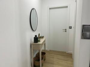 a mirror on a wall in a room with a table at Frades house in Câmara de Lobos +16 photos