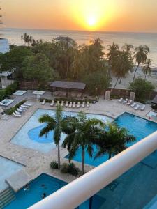 an aerial view of a resort with a pool and the ocean at Reserva del Mar 539 in Santa Marta