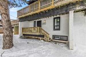 a house with a wooden deck in the snow at Mountain View-Backyard-Air-Conditioning-BBQ-15mins walk Blue Mountain Village in Blue Mountains