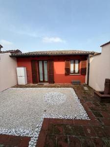 a house with an orange and white house at Guest house Circuit in San Martino del Lago