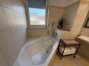 a white bath tub in a bathroom with a window at Residence Loft in Friedrichshafen +22 photos