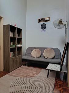 a living room with a couch and a book shelf at Macchiato Homestay - Musslim Homestay in Klang