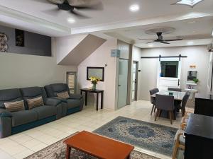 a living room with a couch and a table at Macchiato Homestay - Musslim Homestay in Klang