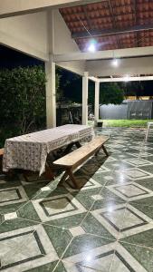 a table and a bench on a patio at Casa Aguiar in Santarém +4 photos