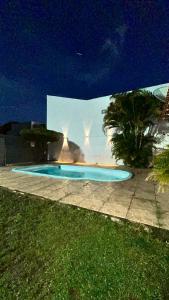 a small swimming pool at night with a wall at Casa Aguiar in Santarém