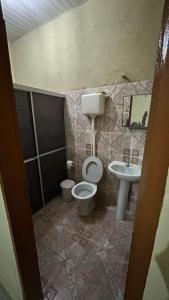 a bathroom with a toilet and a sink at Casa Aguiar in Santarém