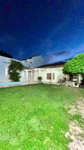 a house with a large yard with green grass at Casa Aguiar in Santarém