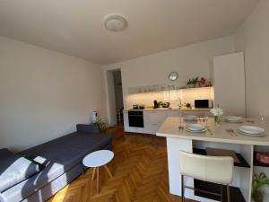 a living room with a couch and a kitchen at Mona Lisa Apartment in Bratislava