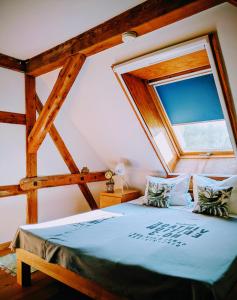 a bed in a room with a large window at Liljas Haus im Spreewald in Burg